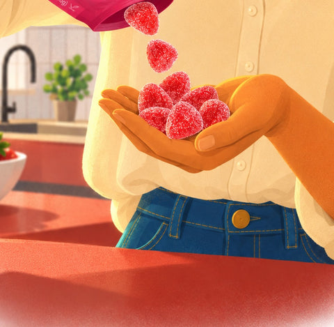 Sour strawberry pieces spill from the pouch into her cupped hands at the kitchen island.