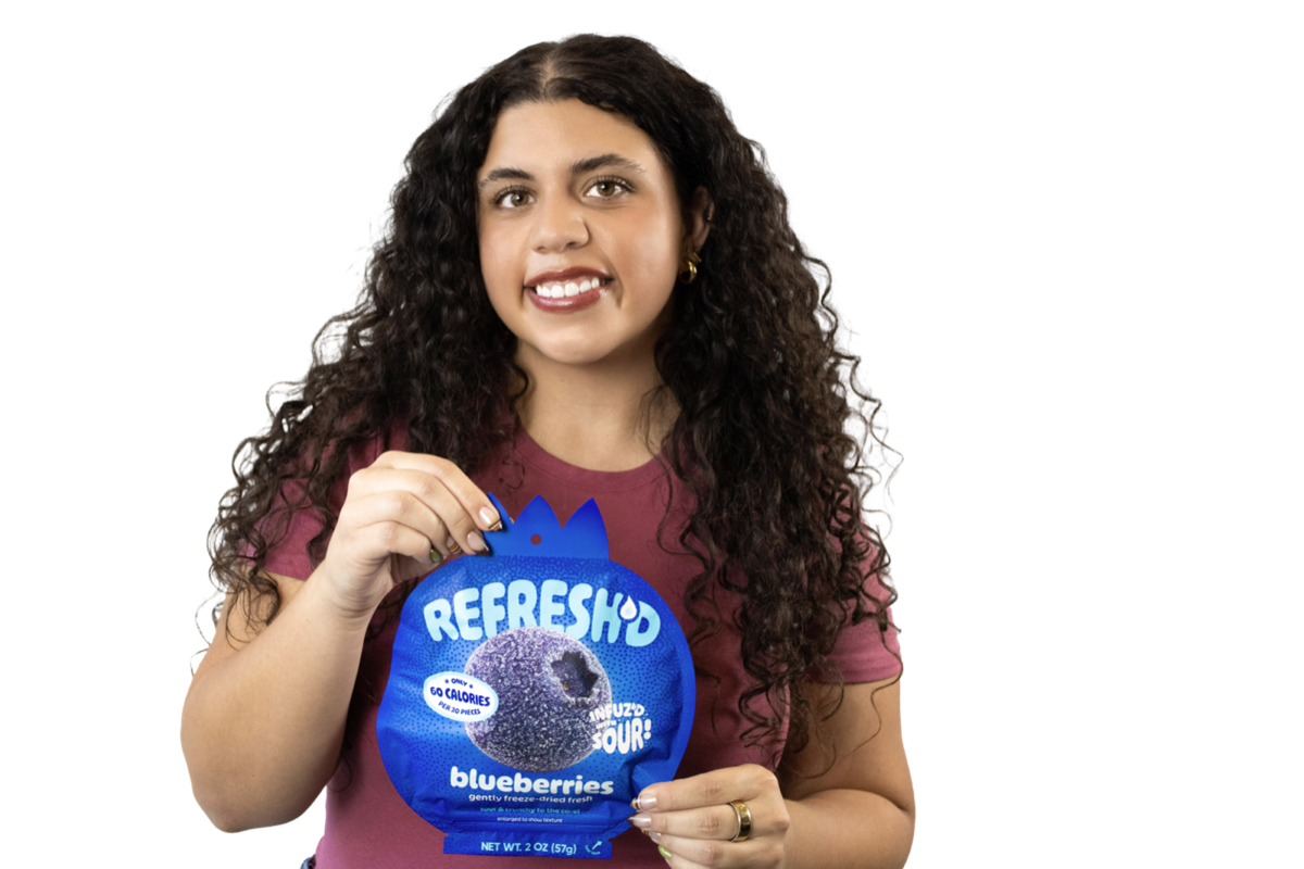 Someone holding a pouch of REFRESH'D sour freeze-dried blueberries.