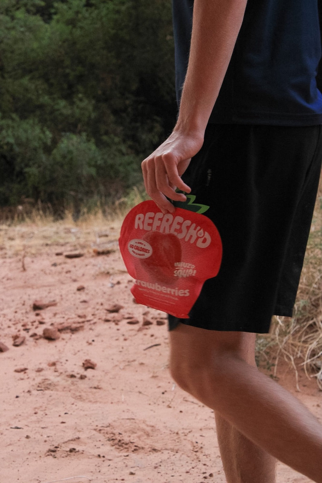 Hike, pack in hand, sour freeze-dried strawberries